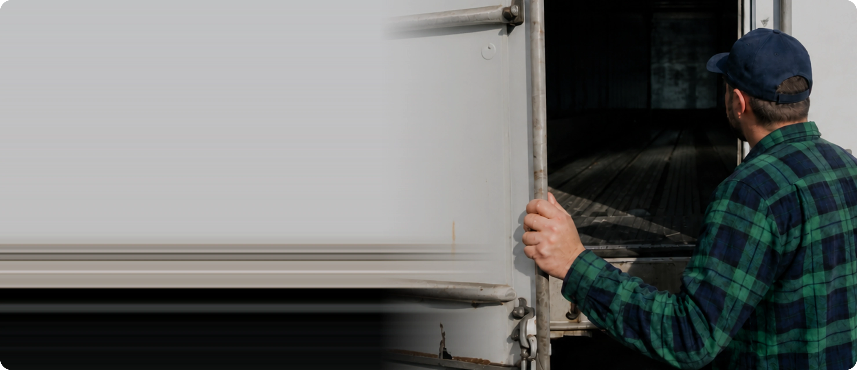 Driver opening the door of an empty trailer